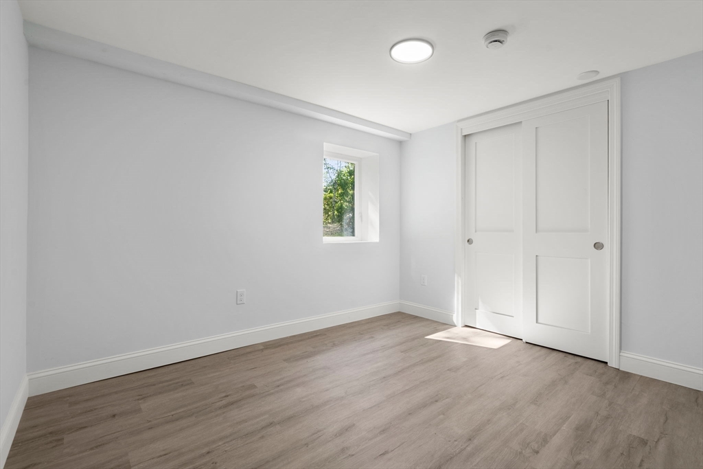 50 Bow Street Saugus, MA 01906 - Photo 28 of 37 a view of an empty room with wooden floor and a window