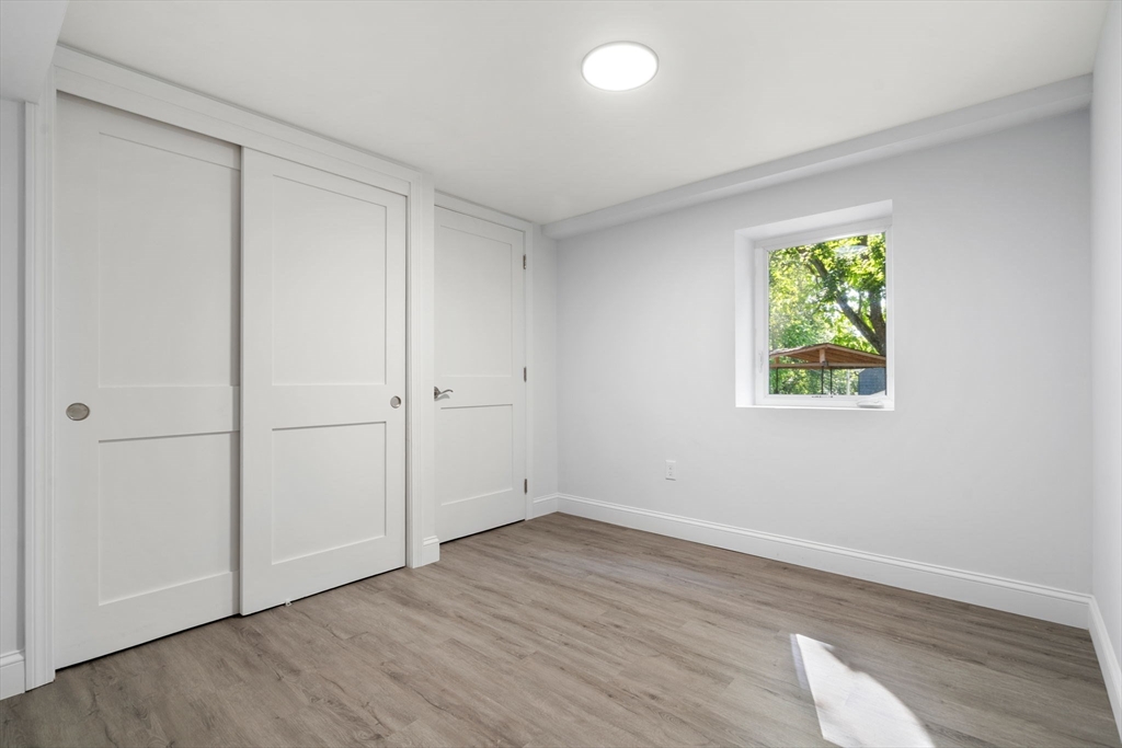 50 Bow Street Saugus, MA 01906 - Photo 30 of 37 an empty room with wooden floor and window