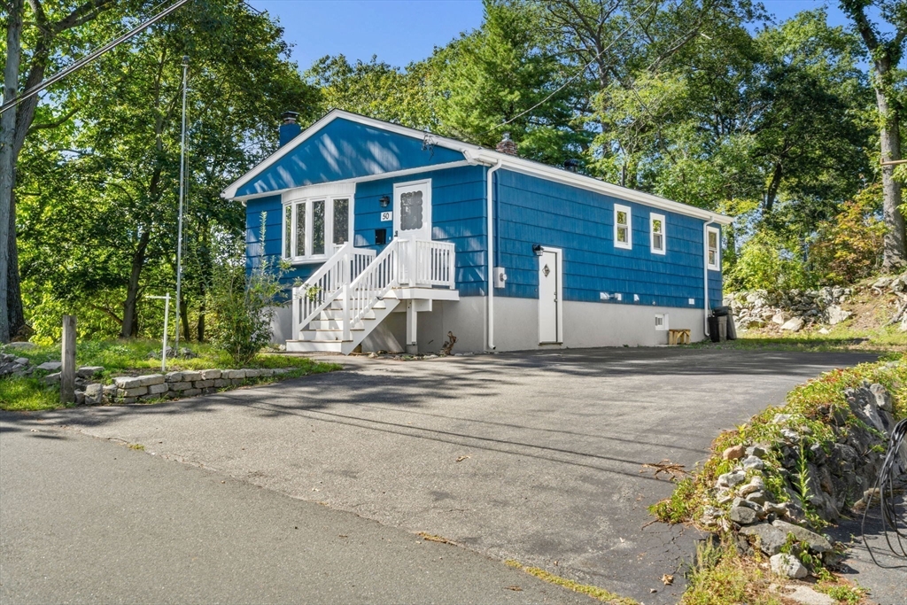 50 Bow Street Saugus, MA 01906 - Photo 32 of 37 a front view of a house with a yard and garage