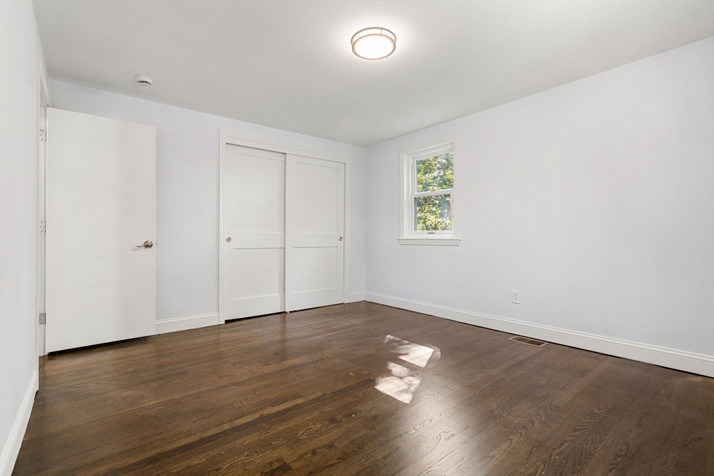 50 Bow Street Saugus, MA 01906 - Photo 5 of 37 an empty room with wooden floor and window