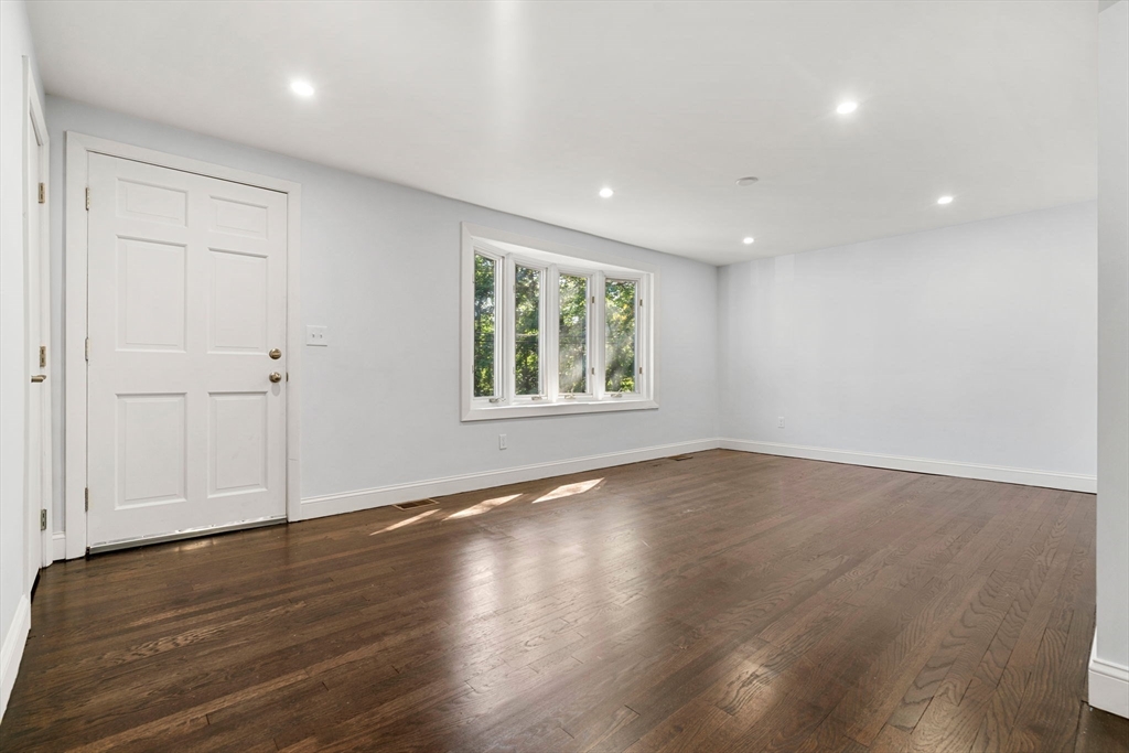 50 Bow Street Saugus, MA 01906 - Photo 7 of 37 an empty room with wooden floor and windows