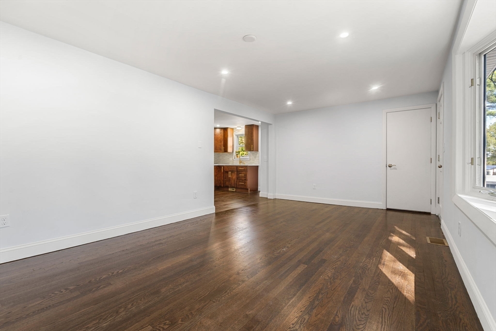 50 Bow Street Saugus, MA 01906 - Photo 9 of 37 an empty room with wooden floor and windows