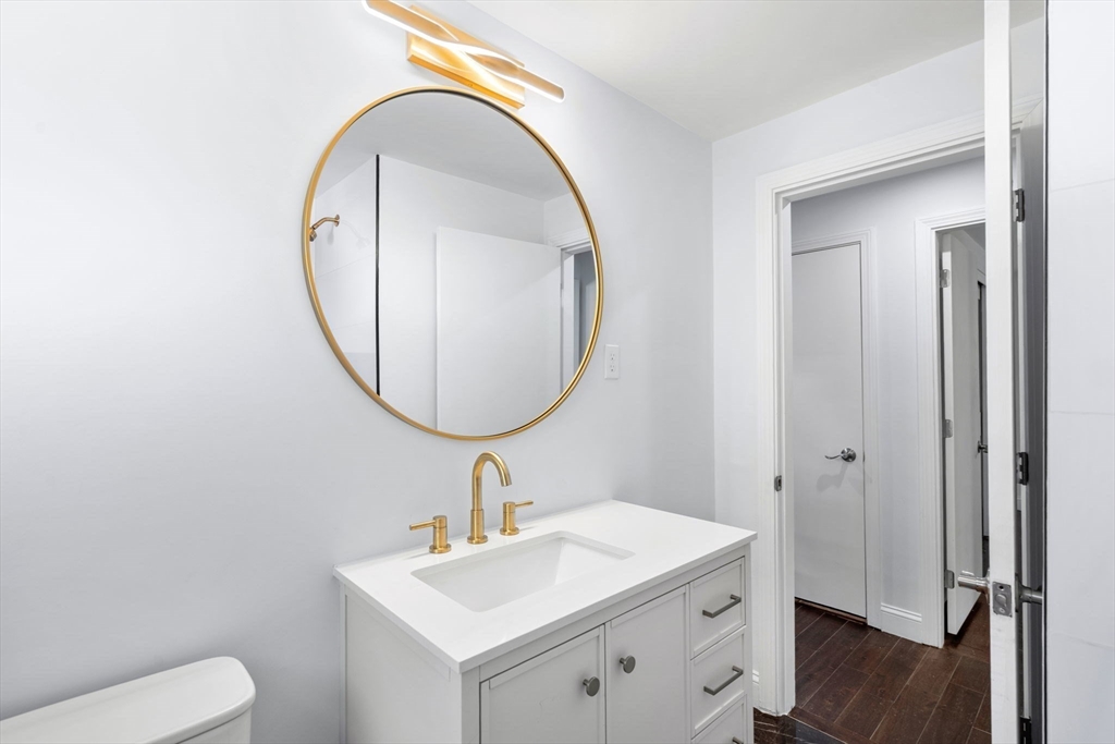 50 Bow Street Saugus, MA 01906 - Photo 10 of 37 a bathroom with a toilet a sink and a mirror