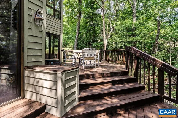 a view of balcony with wooden floor and seating space