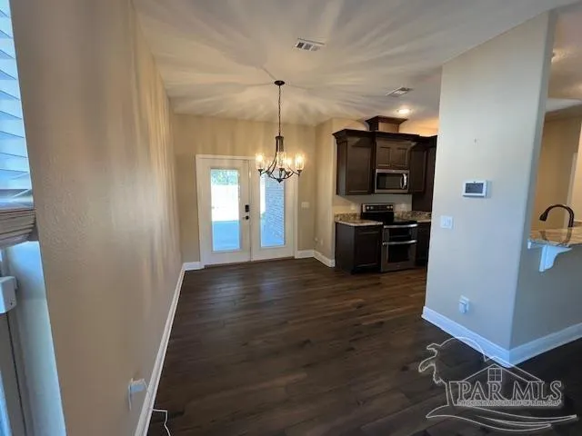 a kitchen with granite countertop stainless steel appliances and wooden cabinets