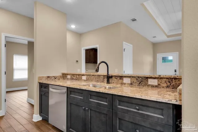 a kitchen with stainless steel appliances granite countertop a stove microwave and refrigerator