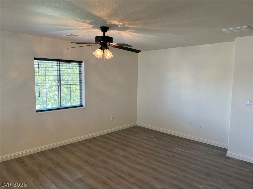 9581 Aberdeen Ridge Court Las Vegas, NV 89148 - Photo 13 of 25 A well-lit bedroom provides comfort with durable flooring and overhead lighting.