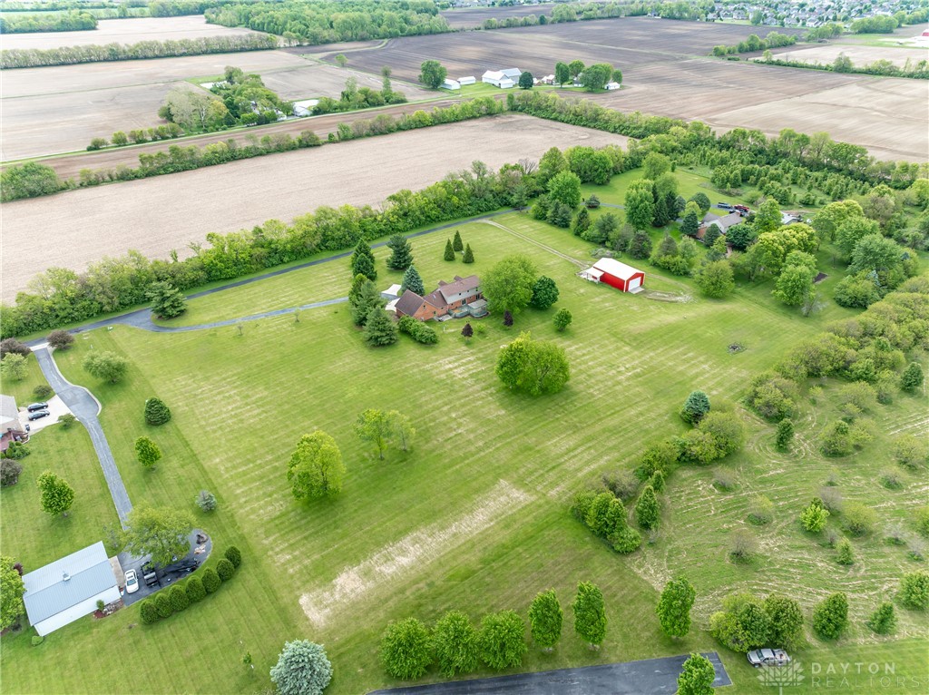 9981 Ridge Acres Lane Englewood, OH 45322 - Photo 55 of 73 This sweeping aerial view showcases a spacious property with lush greenery and distant agricultural fields.