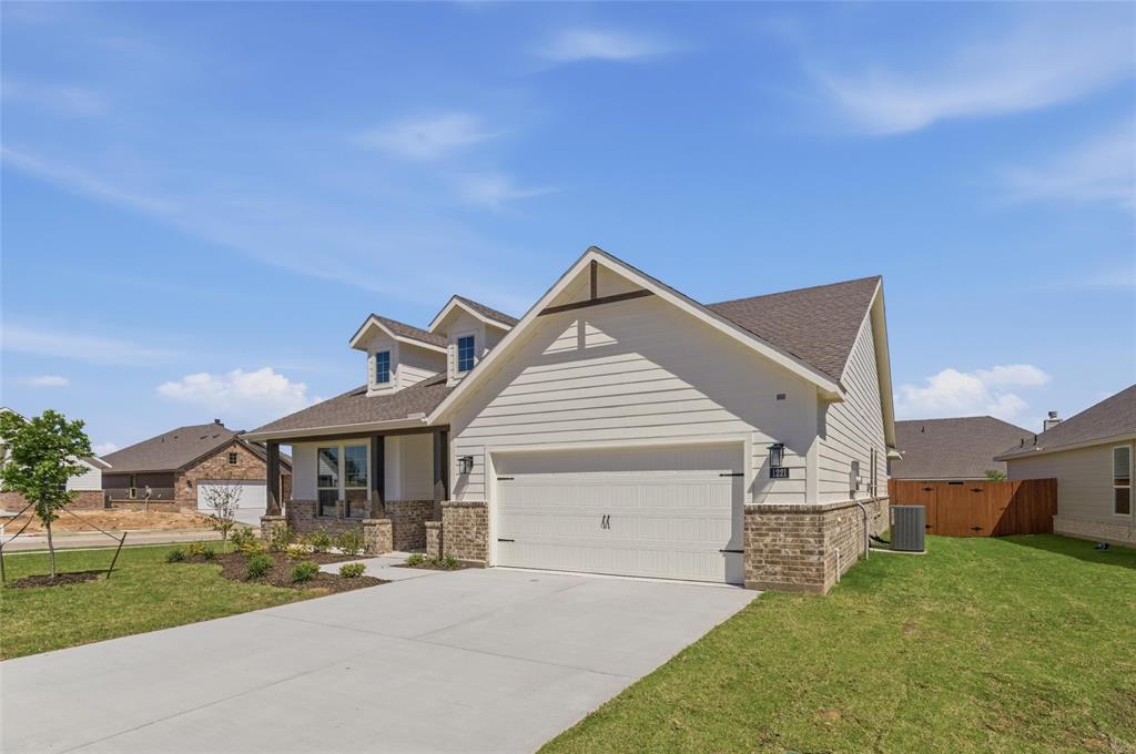 1221 Sabine River Lane Springtown, TX 76082 - Photo 2 of 25 View of front facade with a garage and driveway