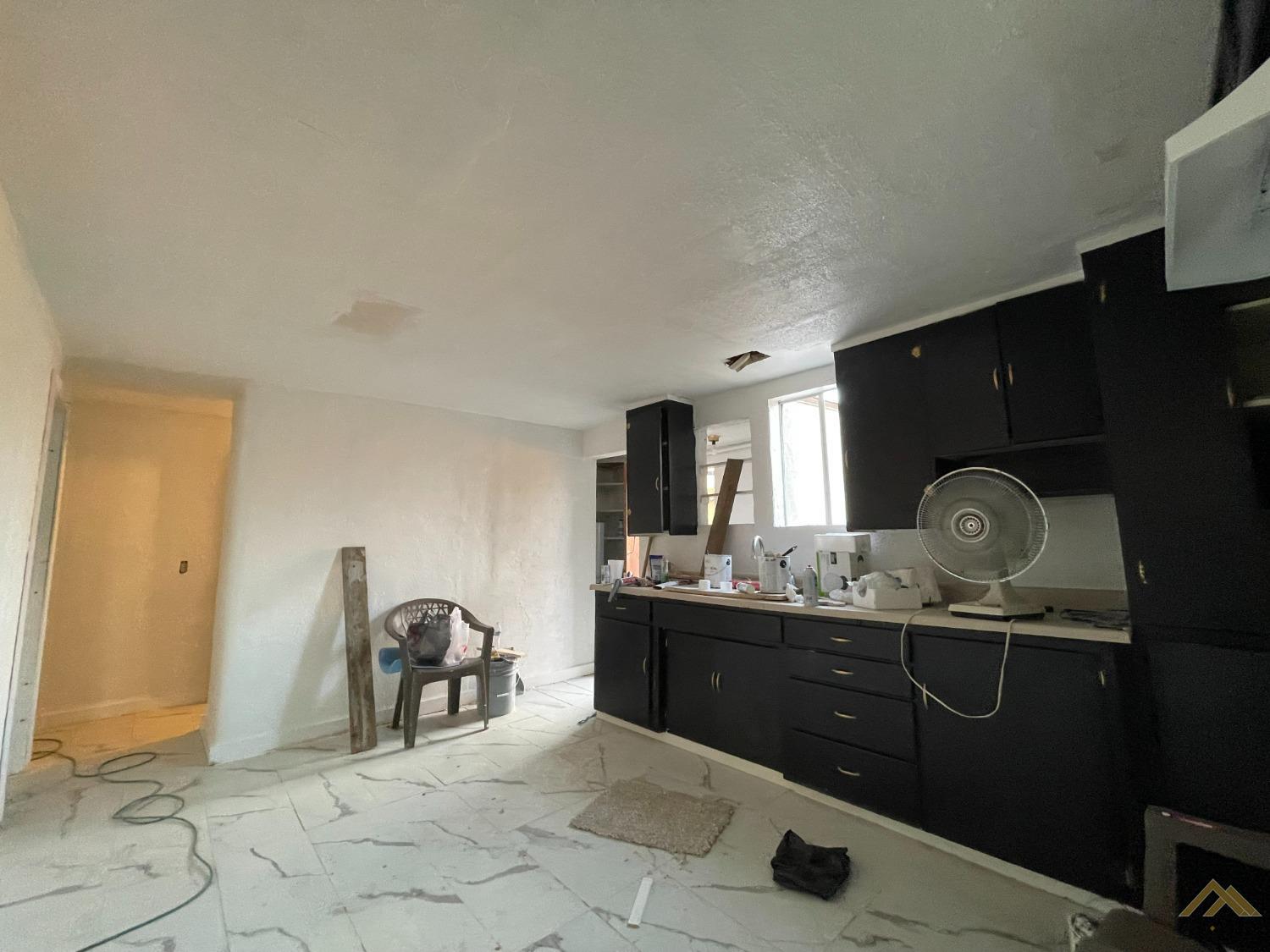 Undisclosed Address Bakersfield, CA 93308 - Photo 11 of 13 a kitchen with granite countertop a sink a stove and cabinets
