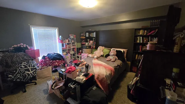 a bedroom with furniture and a window