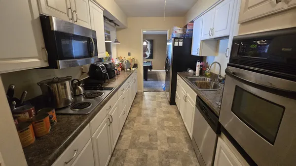 a kitchen with a sink appliances and cabinets