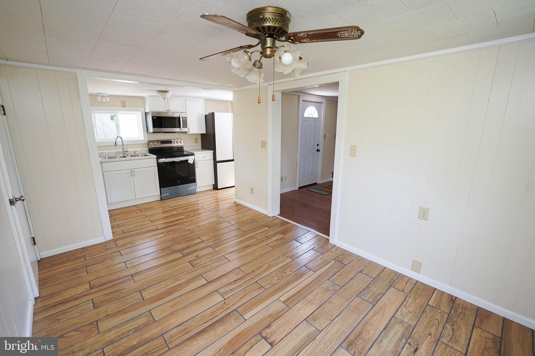 533 East 4th Street Laurel, DE 19956 - Photo 14 of 42 a view of kitchen with sink microwave refrigerator and stove