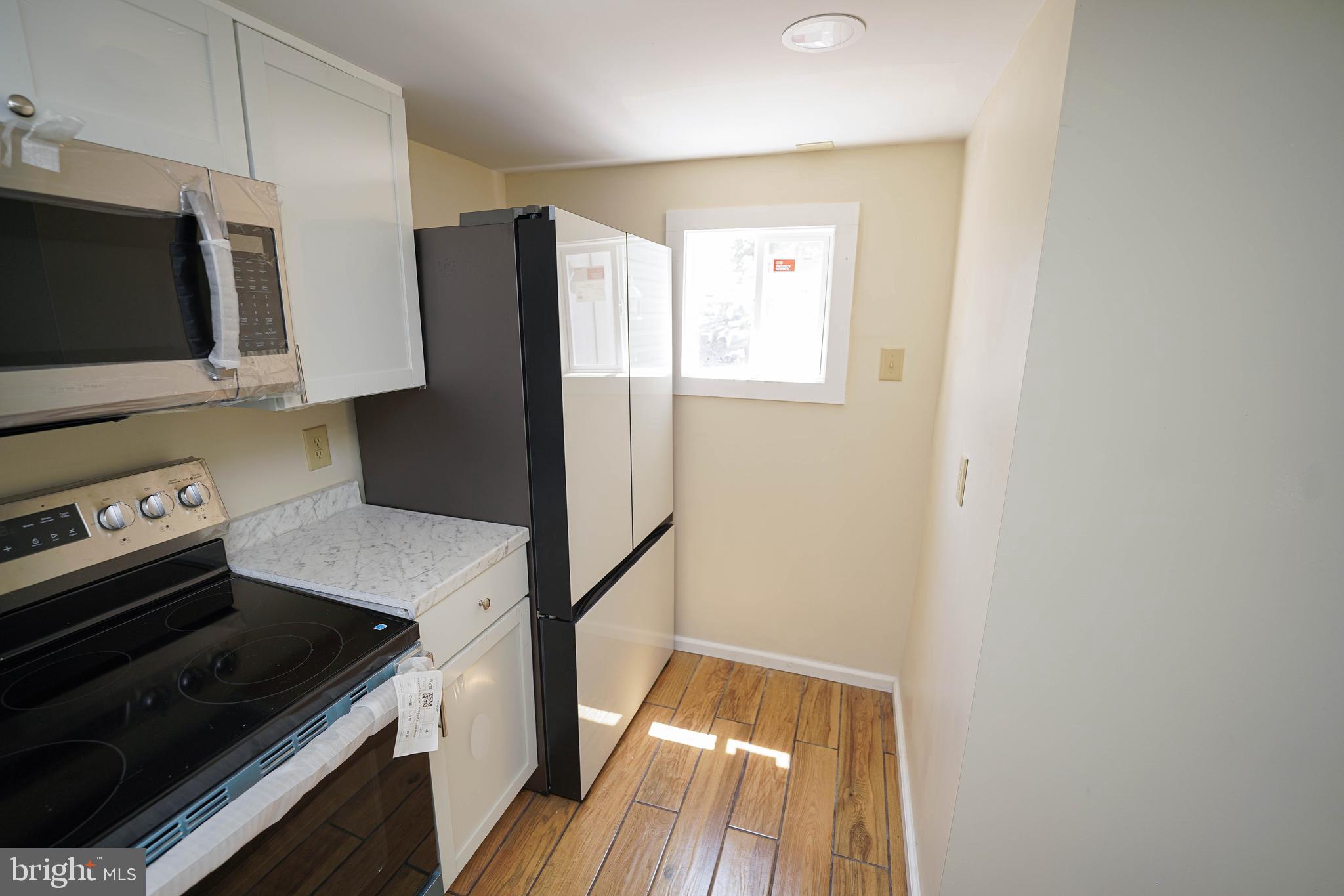 533 East 4th Street Laurel, DE 19956 - Photo 16 of 42 a kitchen with a stove microwave and refrigerator