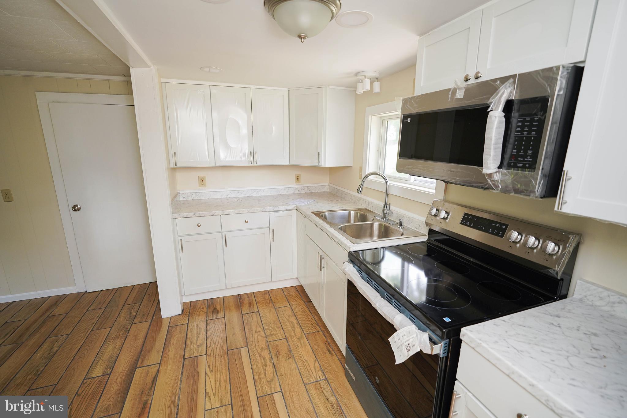 533 East 4th Street Laurel, DE 19956 - Photo 17 of 42 a kitchen with a sink stove and microwave