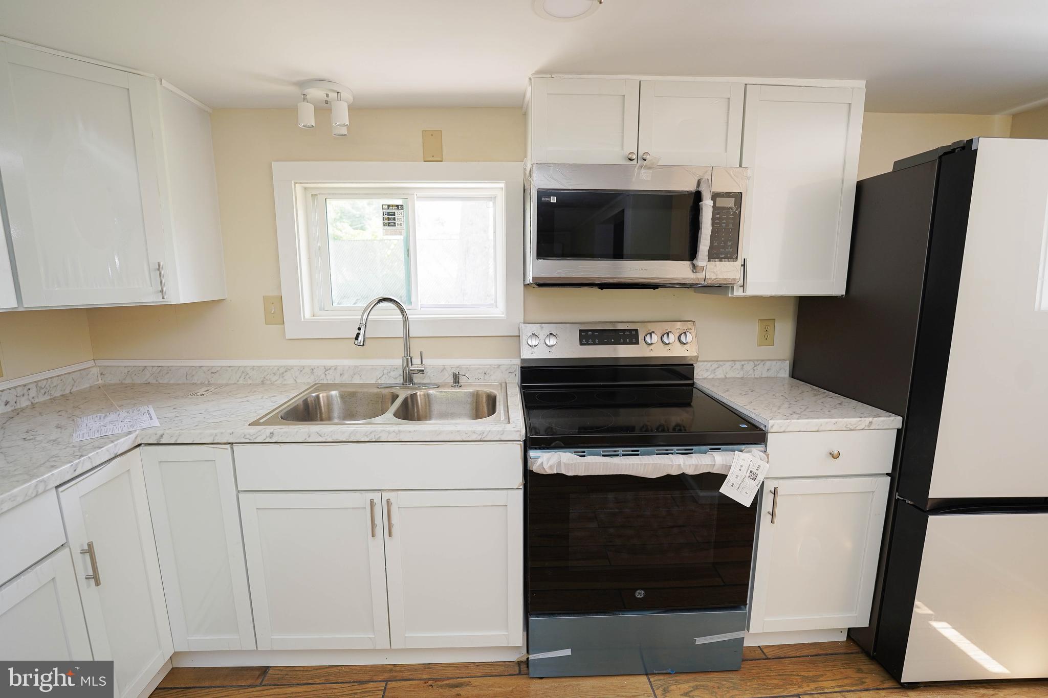 533 East 4th Street Laurel, DE 19956 - Photo 18 of 42 a kitchen with stainless steel appliances granite countertop a sink stove and refrigerator