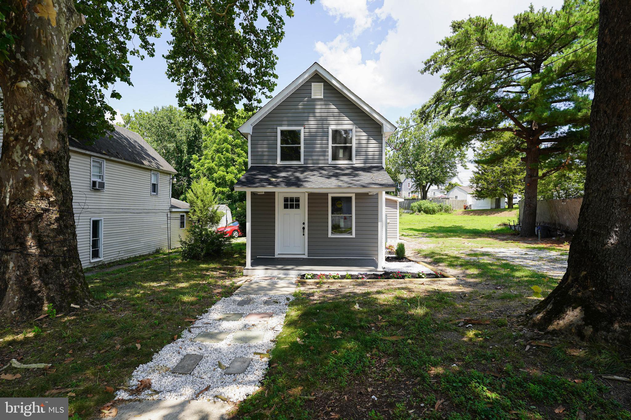 533 East 4th Street Laurel, DE 19956 - Photo 2 of 42 a front view of a house with a yard and trees