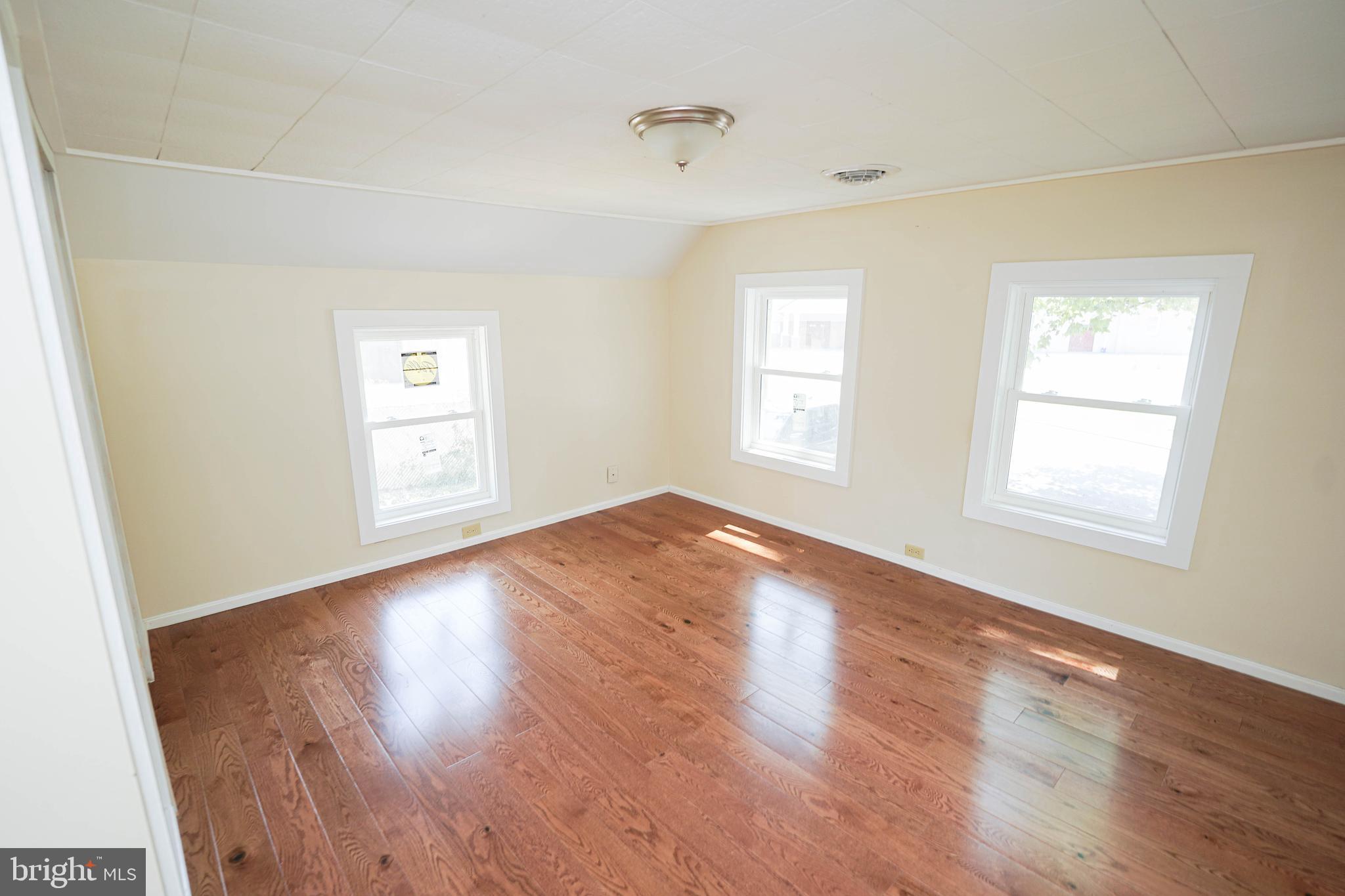 533 East 4th Street Laurel, DE 19956 - Photo 24 of 42 an empty room with wooden floor and windows