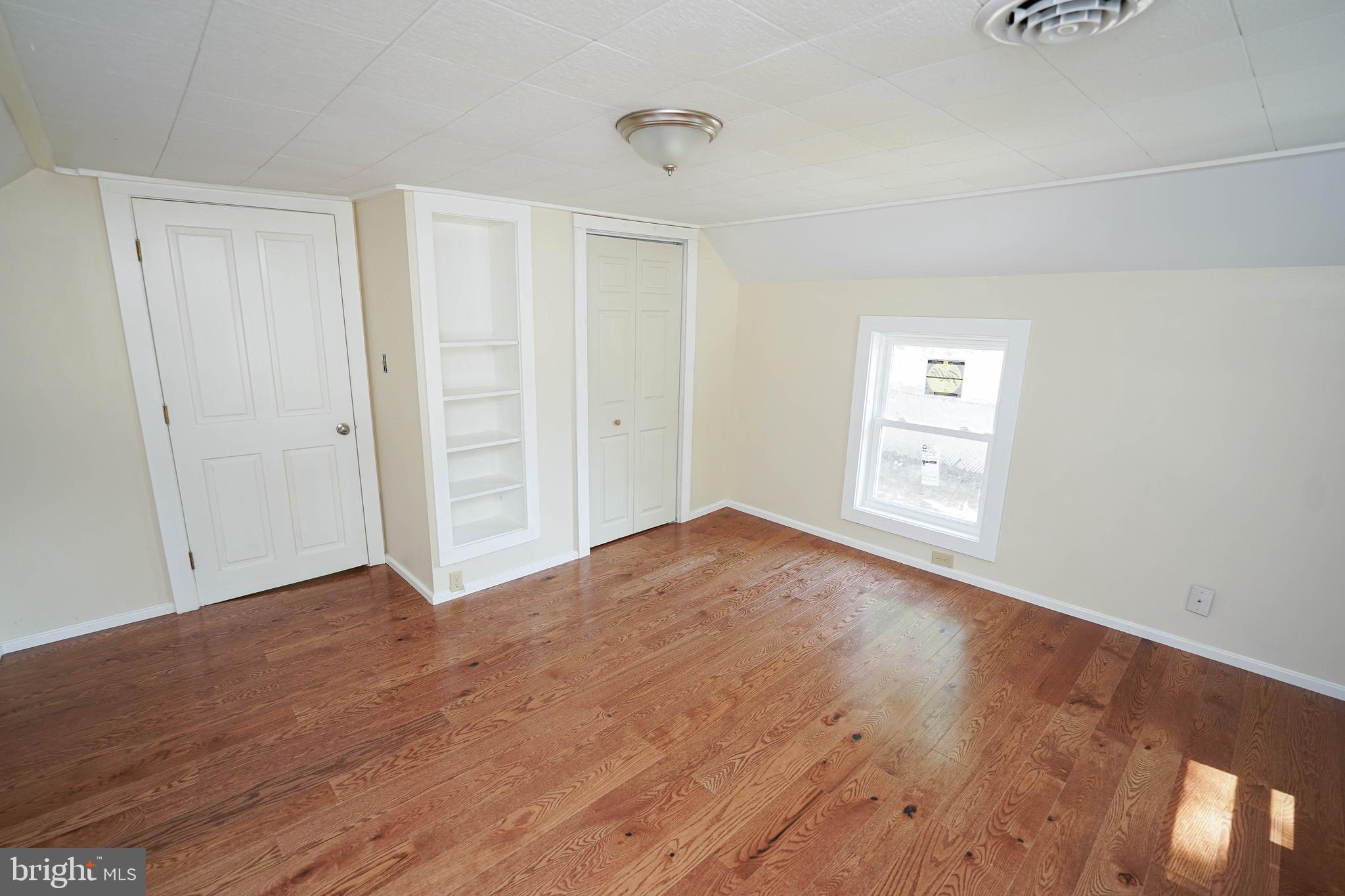 533 East 4th Street Laurel, DE 19956 - Photo 25 of 42 an empty room with wooden floor and windows