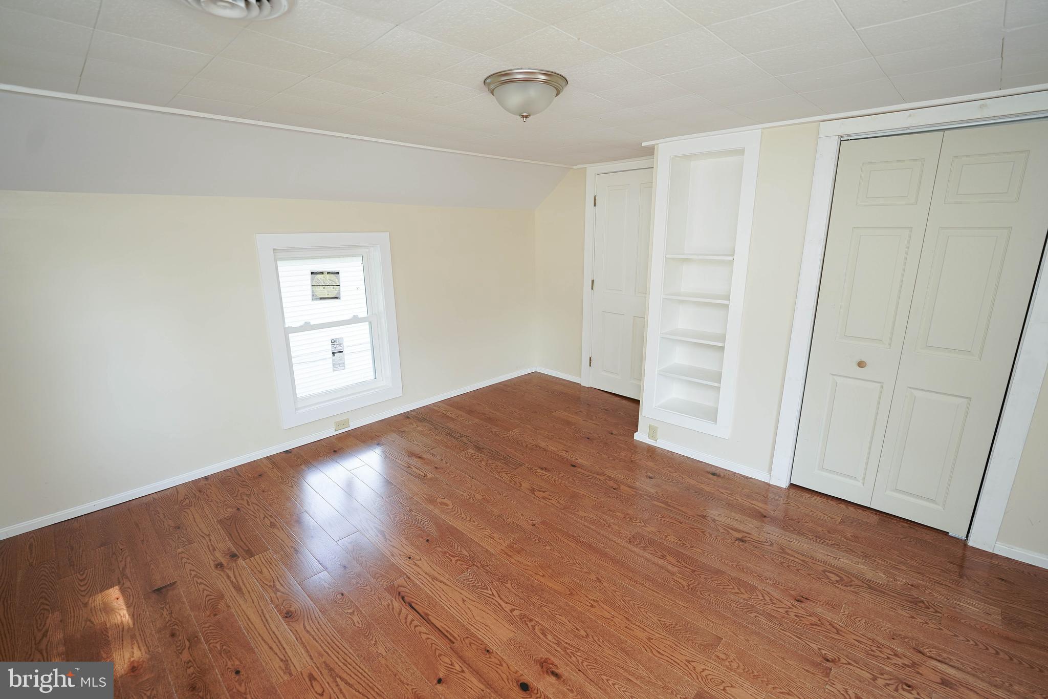 533 East 4th Street Laurel, DE 19956 - Photo 26 of 42 an empty room with wooden floor and windows