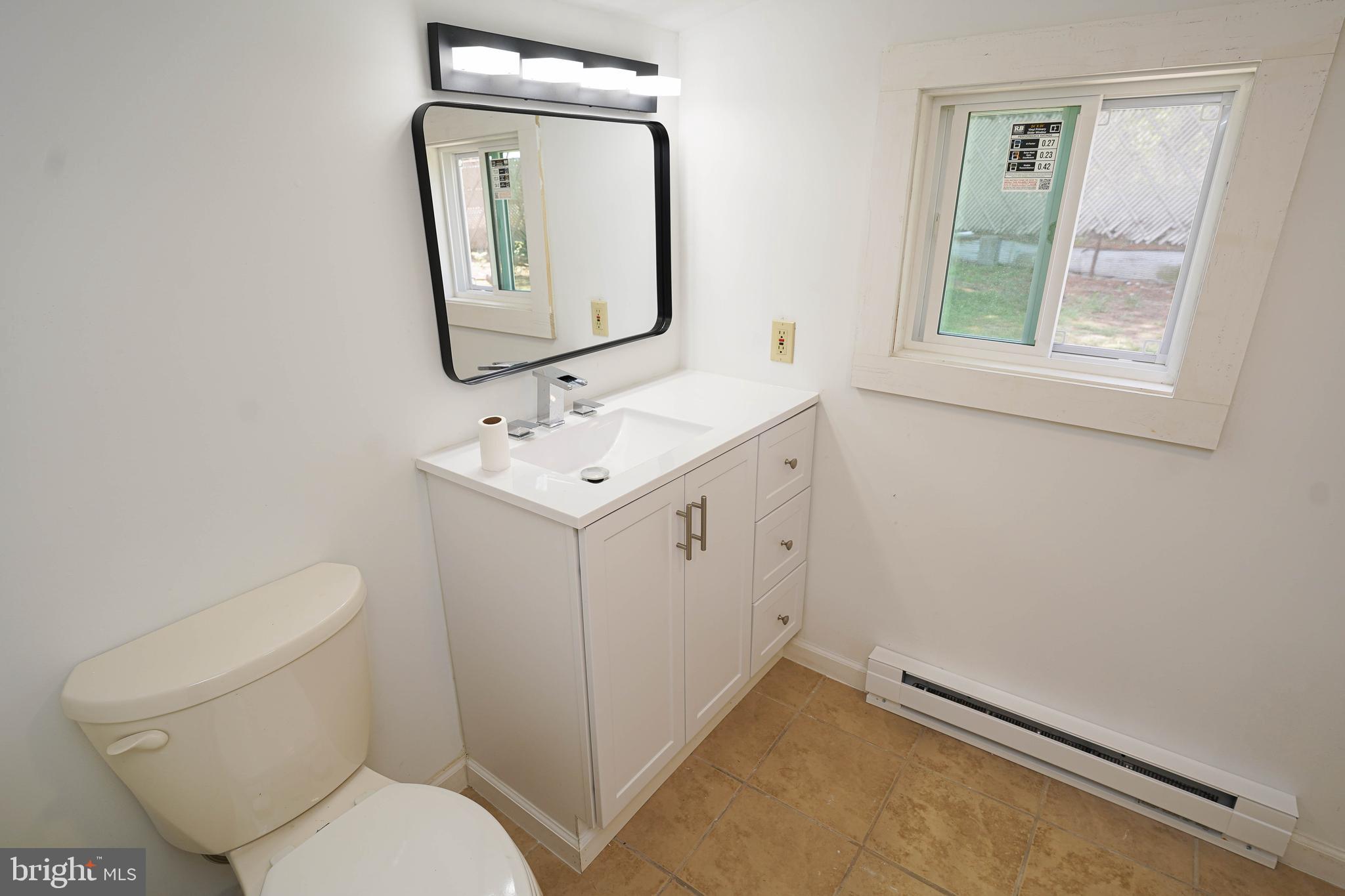 533 East 4th Street Laurel, DE 19956 - Photo 35 of 42 a bathroom with a toilet sink and mirror