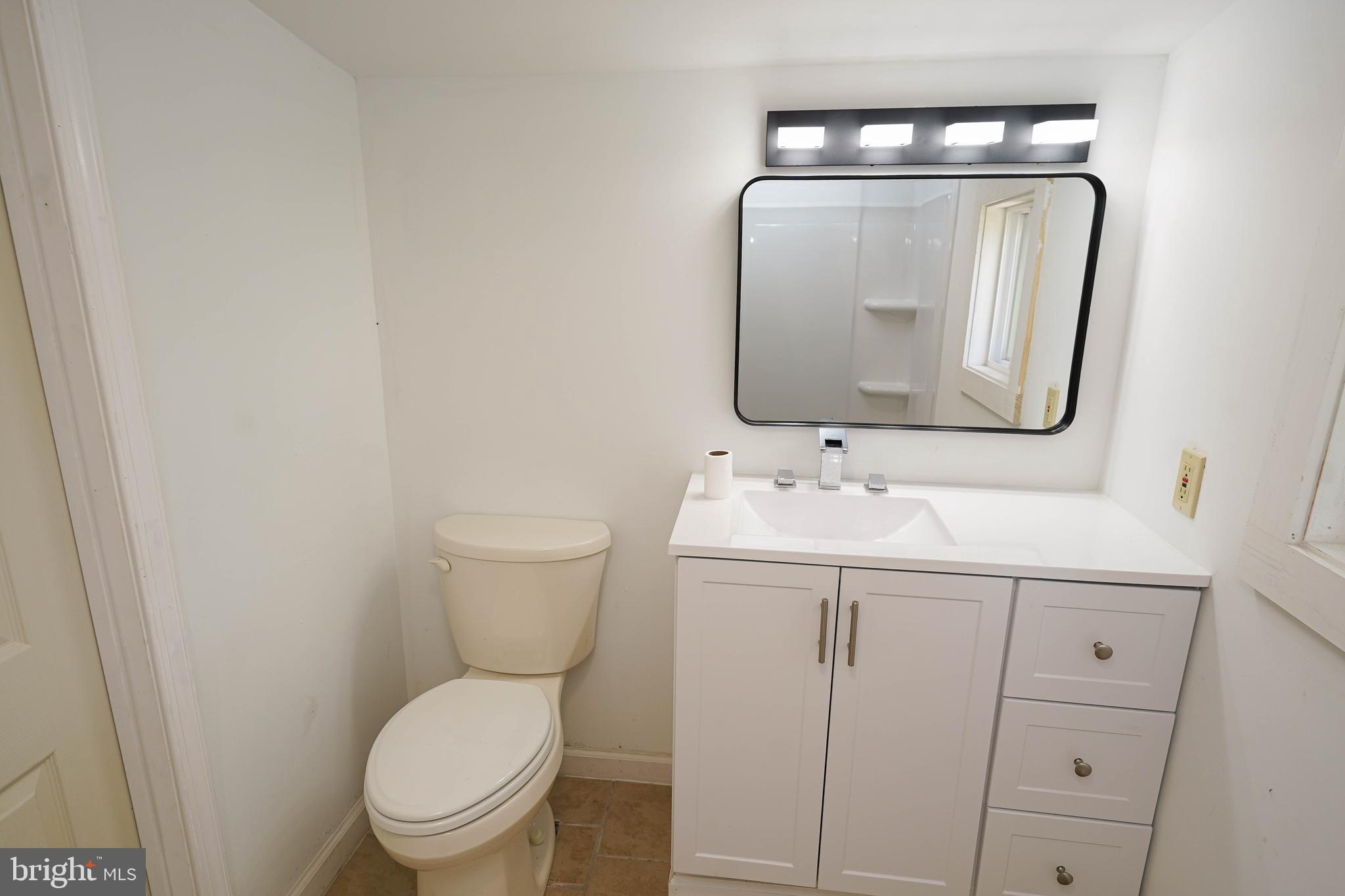 533 East 4th Street Laurel, DE 19956 - Photo 36 of 42 a bathroom with a toilet sink and mirror