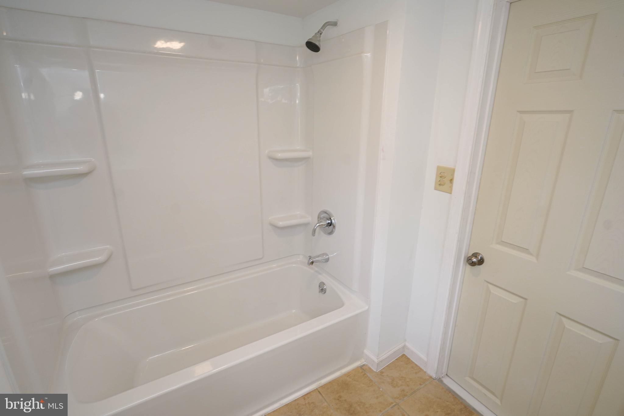533 East 4th Street Laurel, DE 19956 - Photo 37 of 42 a bathroom with a bathtub and a shower
