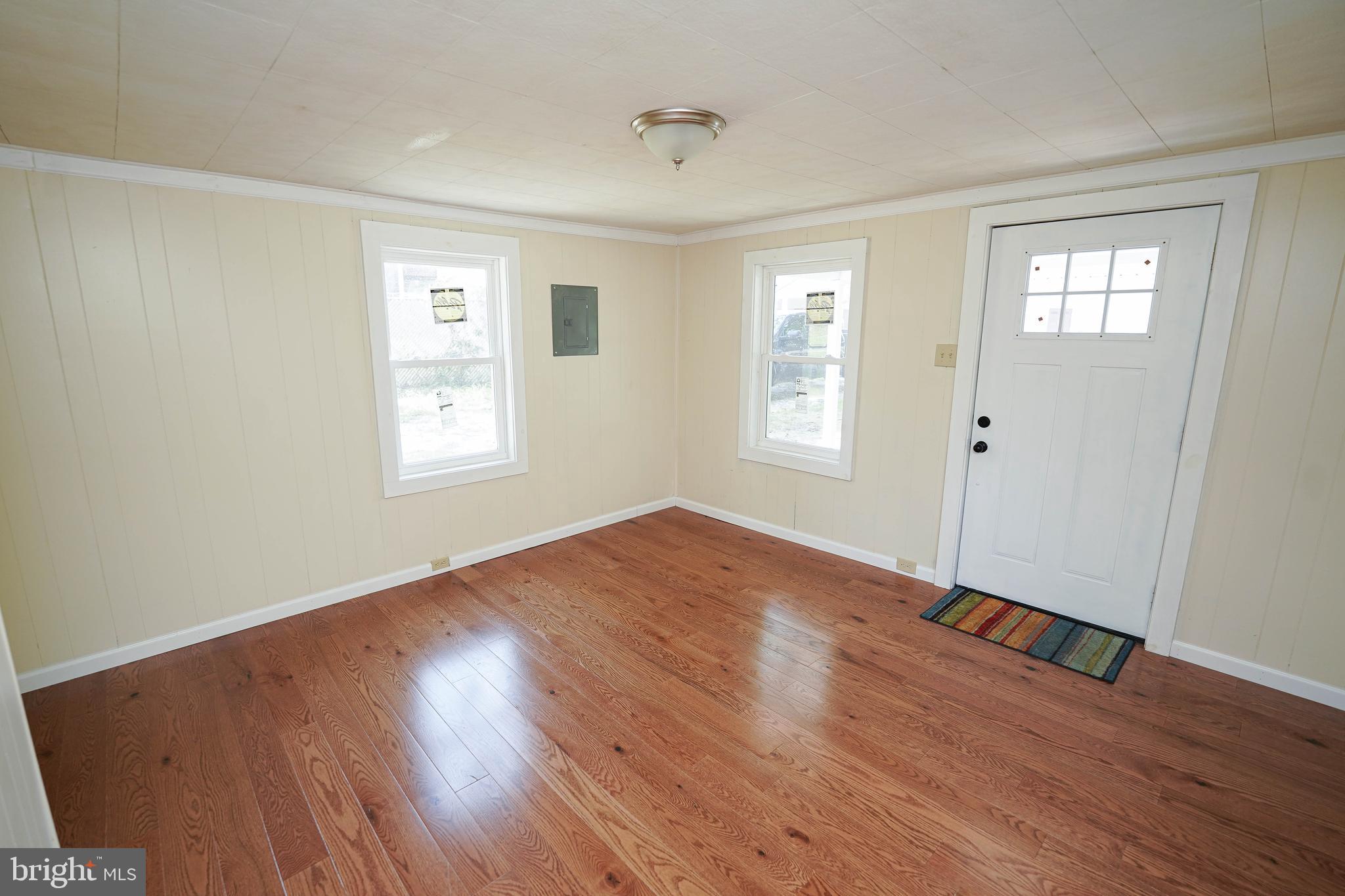 533 East 4th Street Laurel, DE 19956 - Photo 6 of 42 an empty room with wooden floor and windows
