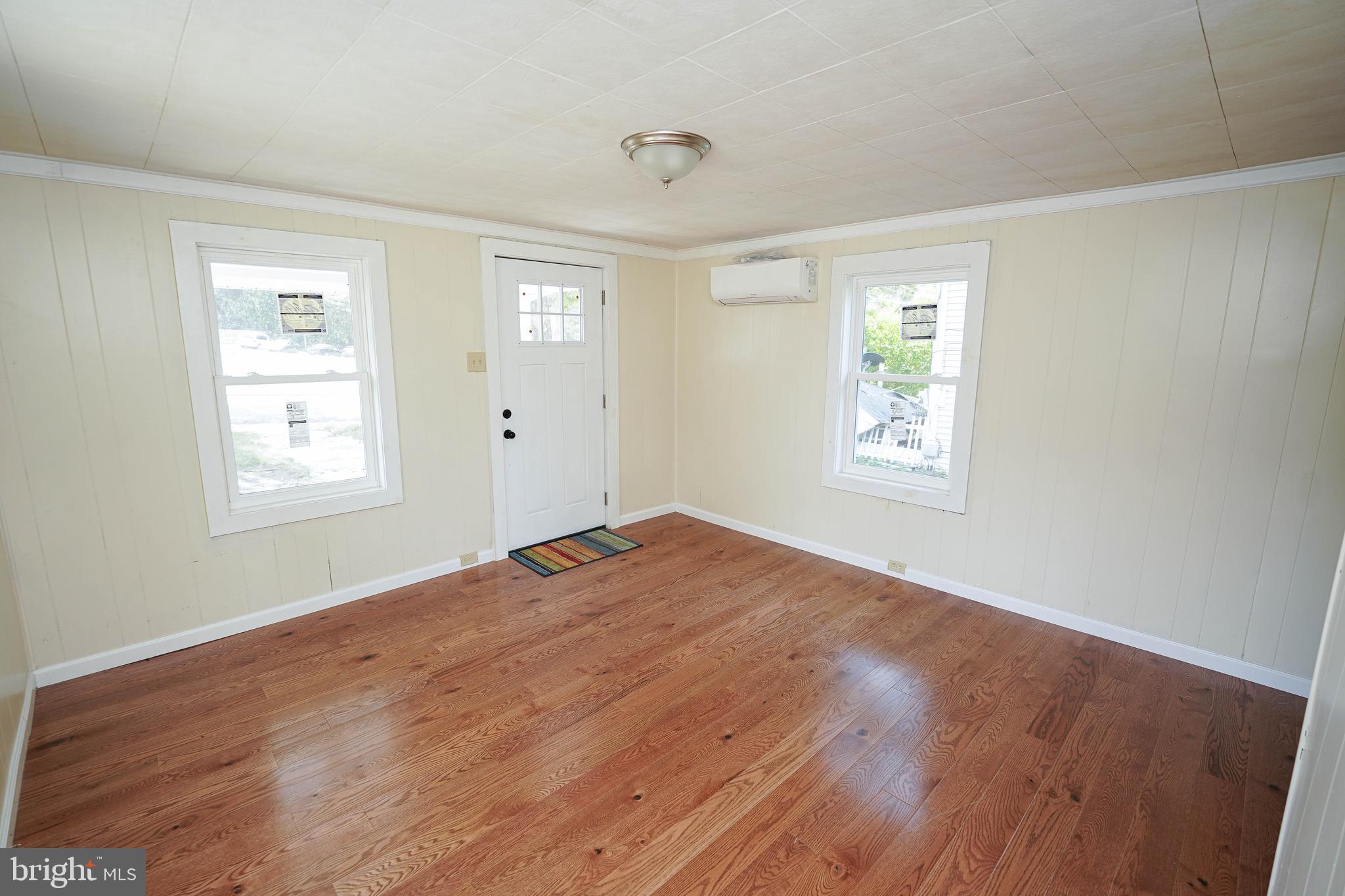 533 East 4th Street Laurel, DE 19956 - Photo 7 of 42 a view of empty room with wooden floor and fan