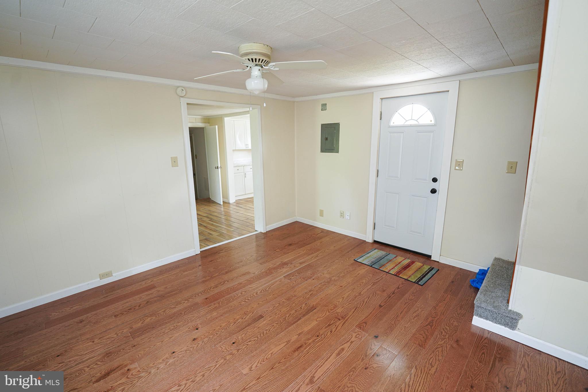 533 East 4th Street Laurel, DE 19956 - Photo 10 of 42 an empty room with wooden floor and windows
