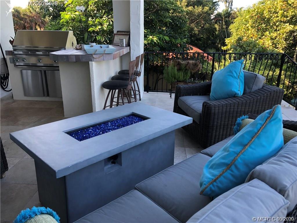 15 Middle Road Stuart, FL 34996 - Photo 15 of 28 a view of a backyard with furniture and a fire pit