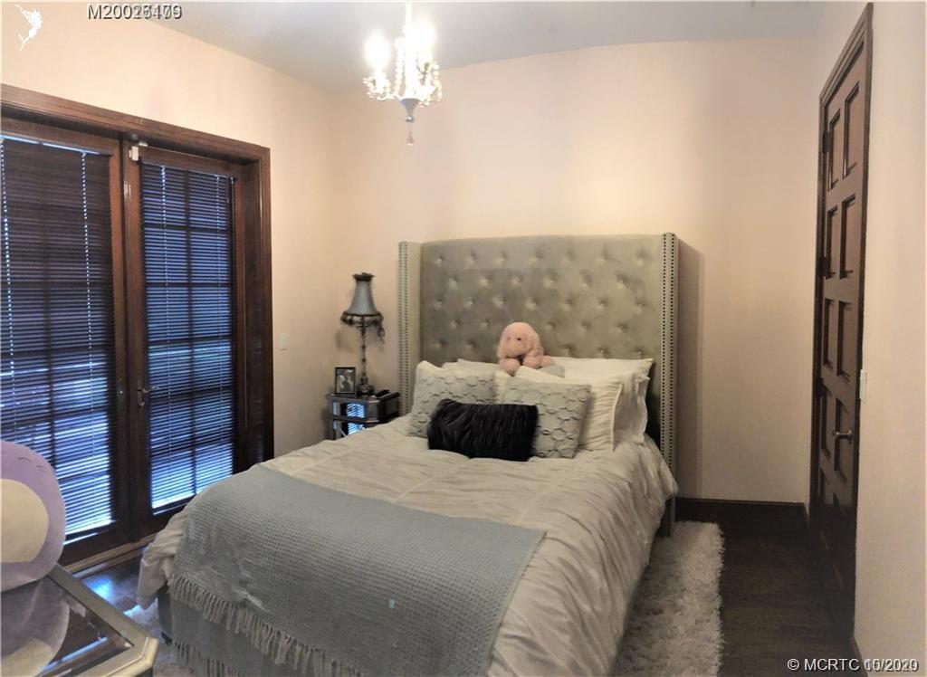 15 Middle Road Stuart, FL 34996 - Photo 18 of 28 a bedroom with a bed and a potted plant