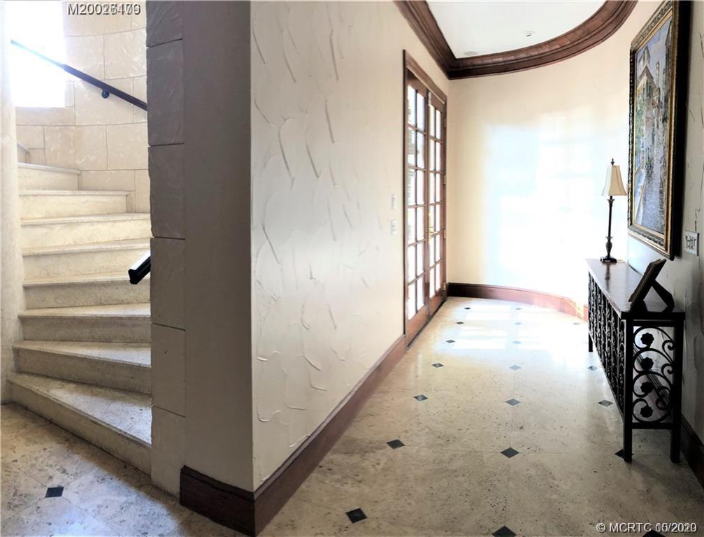 15 Middle Road Stuart, FL 34996 - Photo 2 of 28 a view of a hallway with wooden floor and entryway