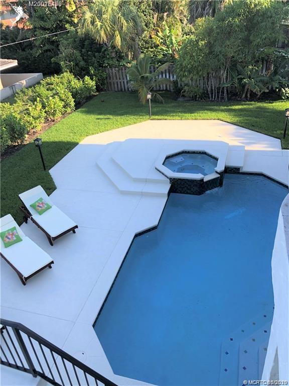 15 Middle Road Stuart, FL 34996 - Photo 21 of 28 a view of a swimming pool with a yard