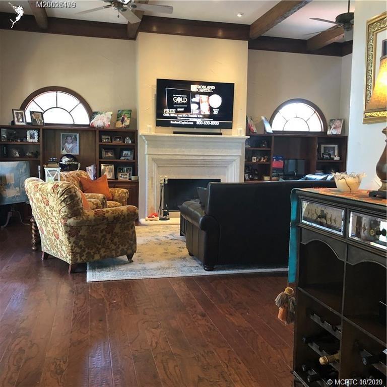 15 Middle Road Stuart, FL 34996 - Photo 27 of 28 a living room with furniture a fireplace and a flat screen tv
