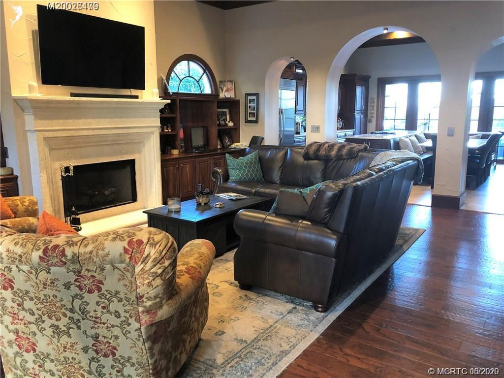 15 Middle Road Stuart, FL 34996 - Photo 3 of 28 a living room with furniture a fireplace and a flat screen tv