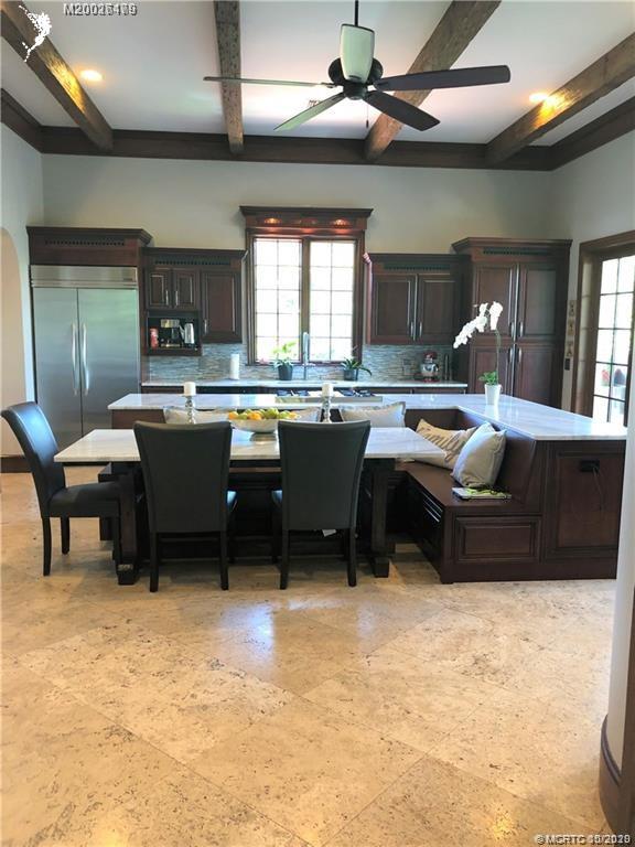 15 Middle Road Stuart, FL 34996 - Photo 4 of 28 a living room with couches a large dining table and chairs with dishwasher kitchen view