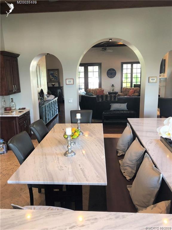 15 Middle Road Stuart, FL 34996 - Photo 5 of 28 a living room with furniture and a mirror