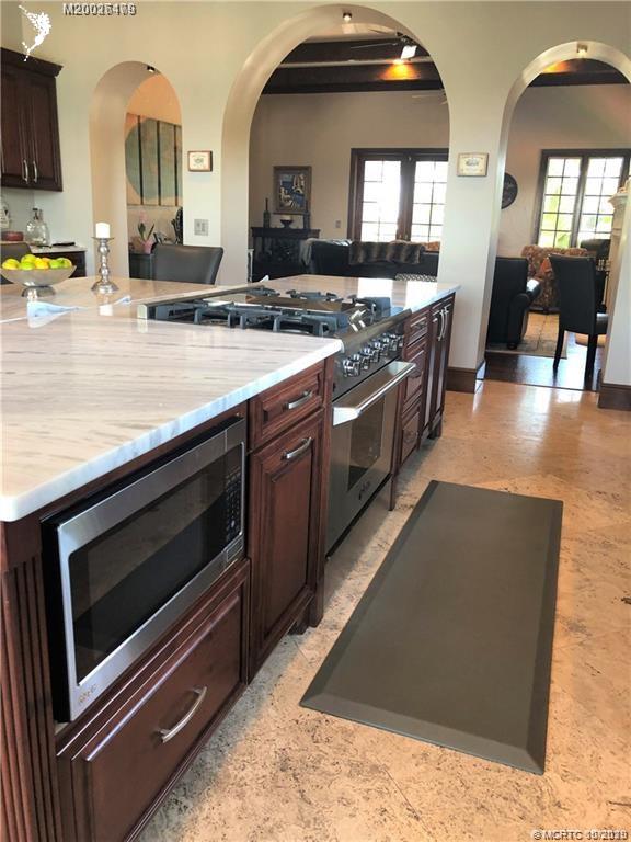 15 Middle Road Stuart, FL 34996 - Photo 6 of 28 a kitchen with stainless steel appliances a stove a sink and a microwave