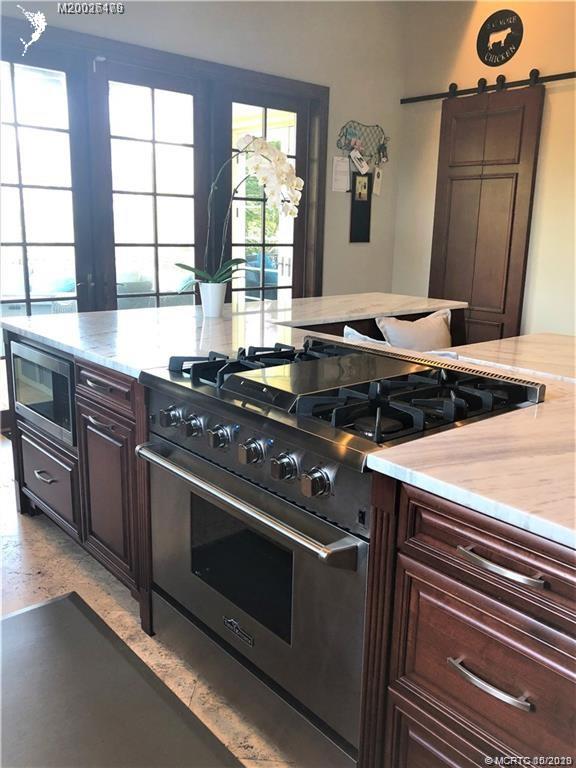 15 Middle Road Stuart, FL 34996 - Photo 8 of 28 a kitchen with stainless steel appliances granite countertop a stove and a sink