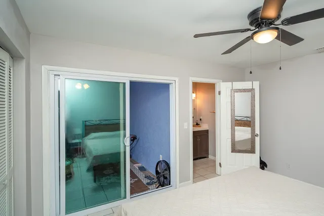 a view of a room that has a bed and wooden floor