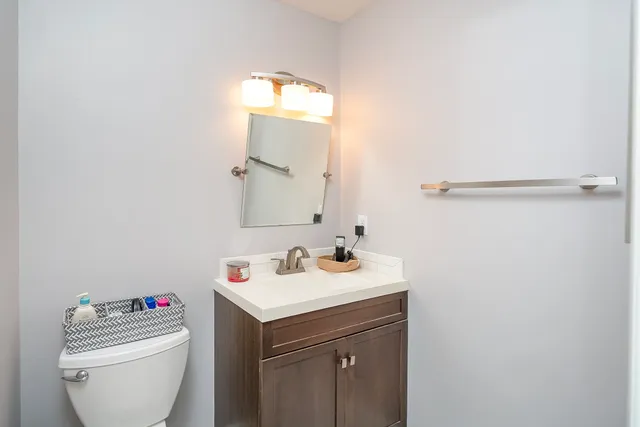 a bathroom with a sink toilet and a mirror