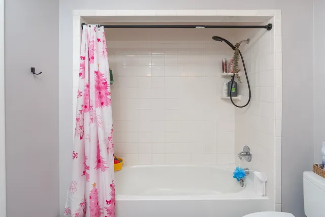 a bathroom with a bathtub and shower