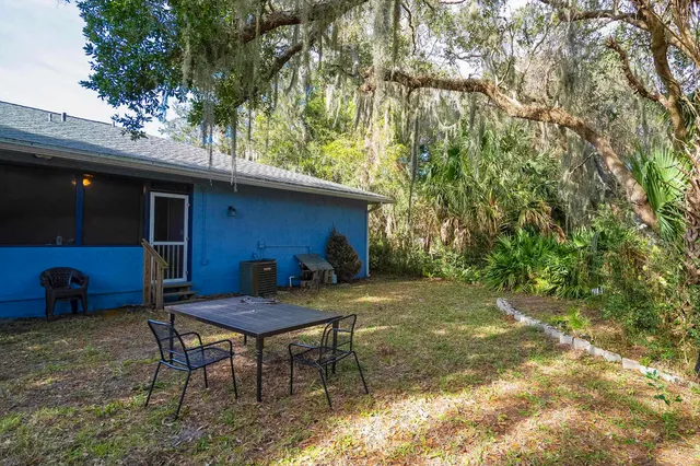 a view of a backyard with large trees