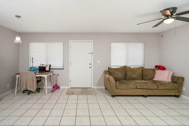 a living room with furniture and a chandelier