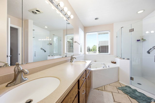 776 Flint Street Layton, UT 84041 - Photo 12 of 41 Double vanity with undermount sinks, a built-in corner soaking tub, a separate glass-enclosed shower, and a large wall mirror
