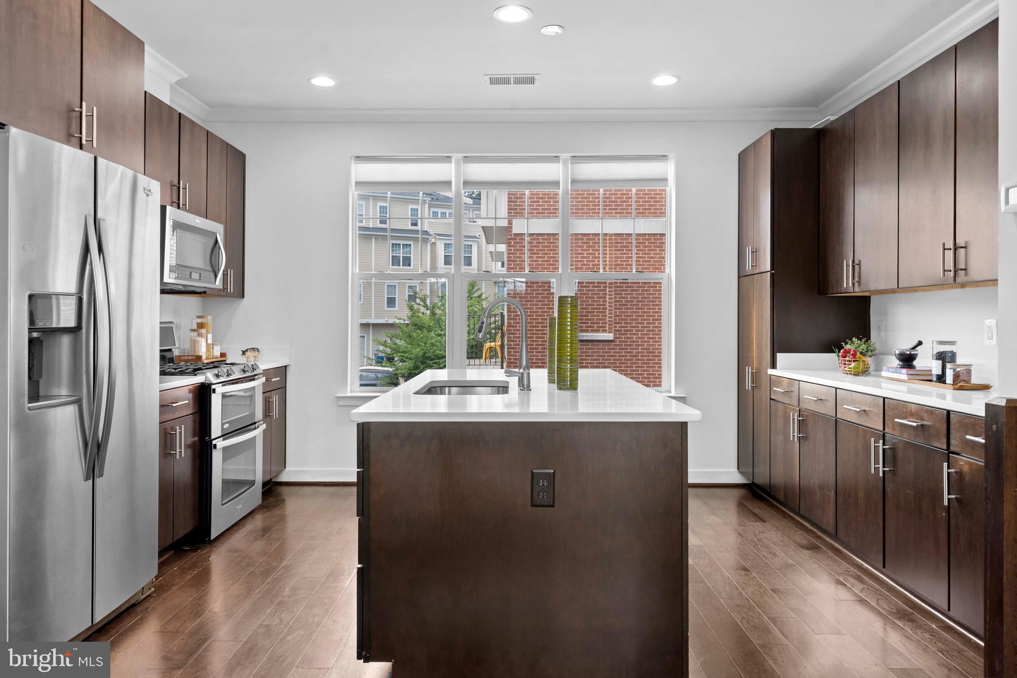 3334 7th Street Northeast Washington, DC 20017 - Photo 14 of 38 a kitchen with cabinets and stainless steel appliances