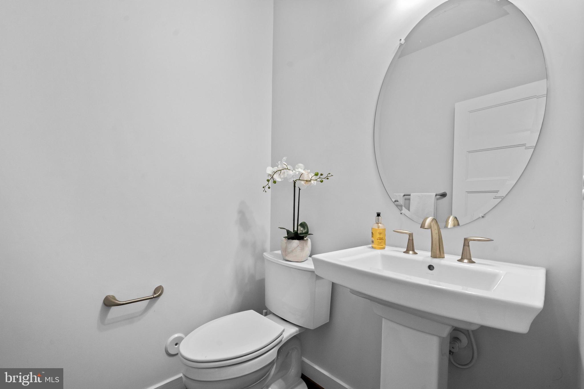 3334 7th Street Northeast Washington, DC 20017 - Photo 19 of 38 a bathroom with a sink a toilet and mirror