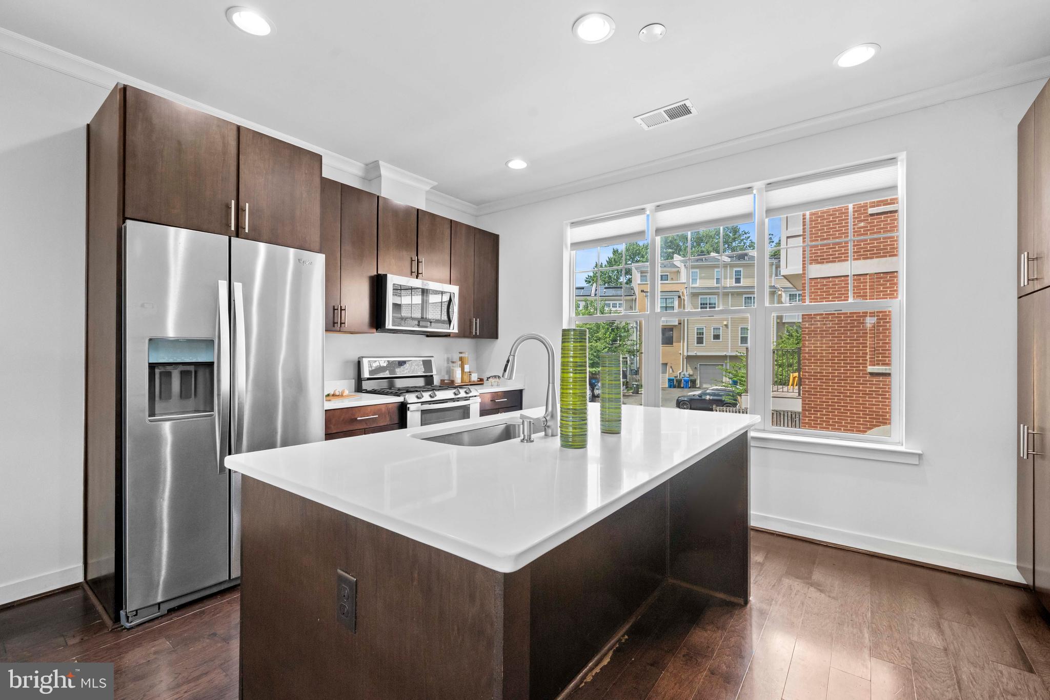 3334 7th Street Northeast Washington, DC 20017 - Photo 10 of 38 a kitchen with kitchen island a counter top space a sink stainless steel appliances and cabinets