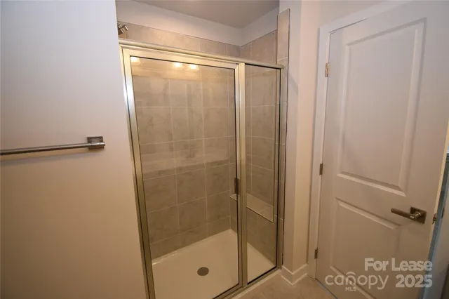a bathroom with a glass shower door